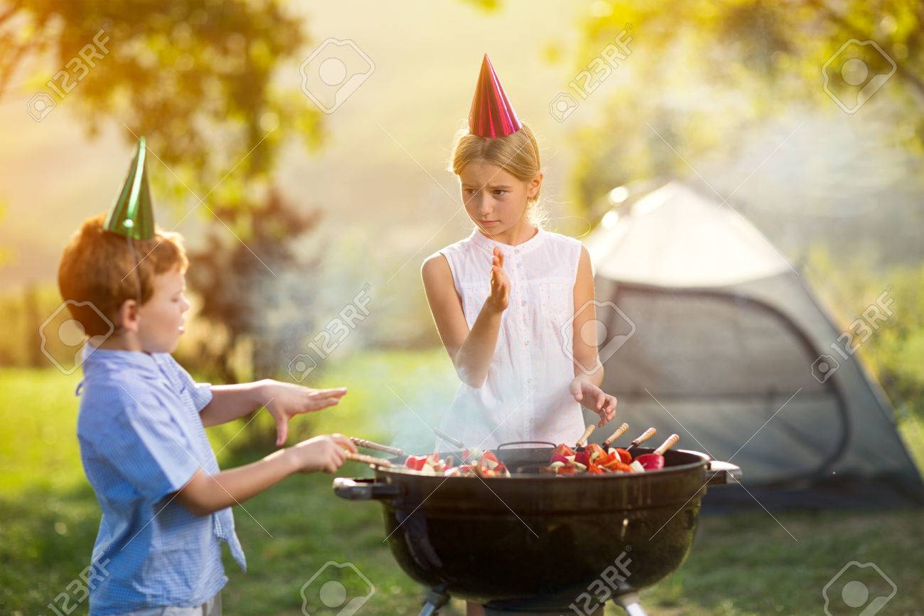 children having a barbecue party on camping - 55667732 children having a barbecue party on camping - 55667732