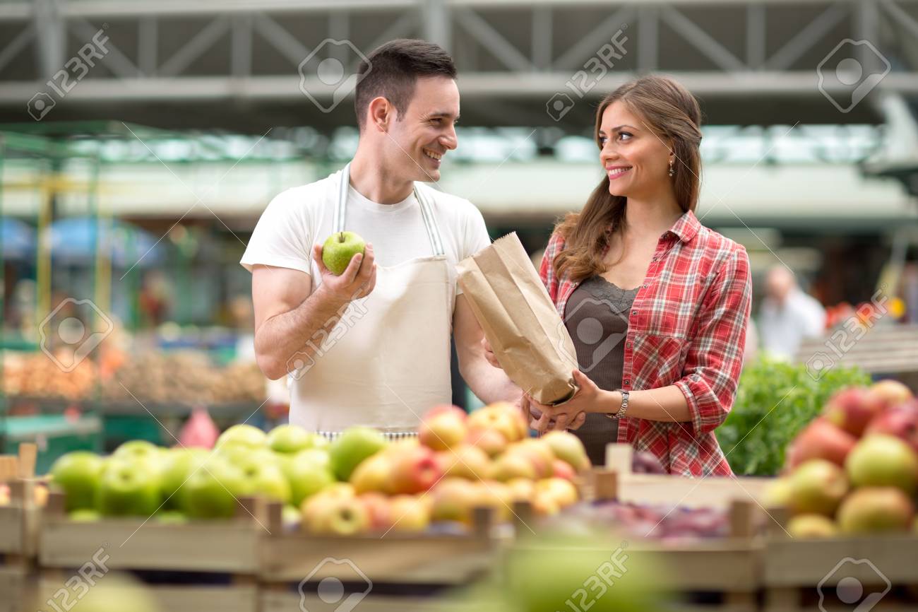 smile salesman presentation produces at the market stock photo