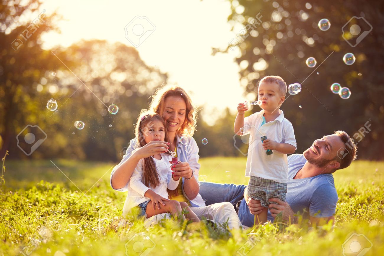 Family with children blow soap bubbles nature - 73427074 Family with children blow soap bubbles nature - 73427074