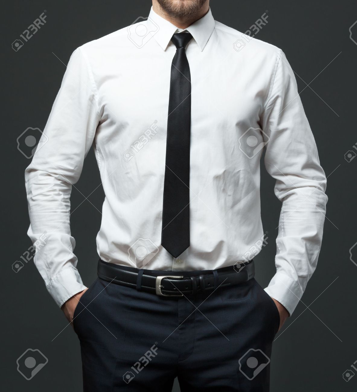 Midsection of fit young businessman standing in formal white shirt, black tie and pants. - 59455978 Midsection of fit young businessman standing in formal white shirt, black tie and pants. - 59455978