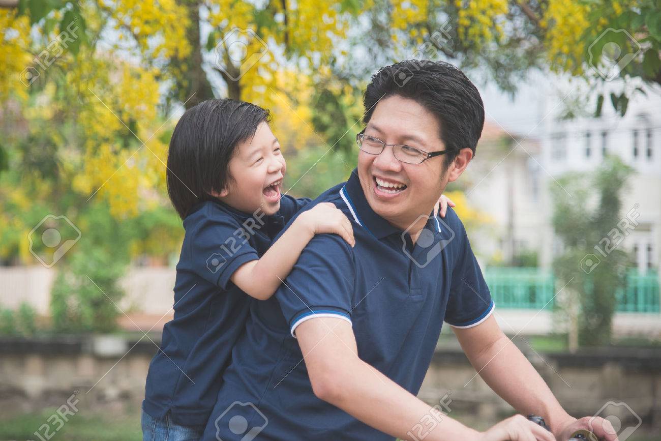 Happy Asian father and son riding bicycle together with spring background - 78279071 Happy Asian father and son riding bicycle together with spring background - 78279071