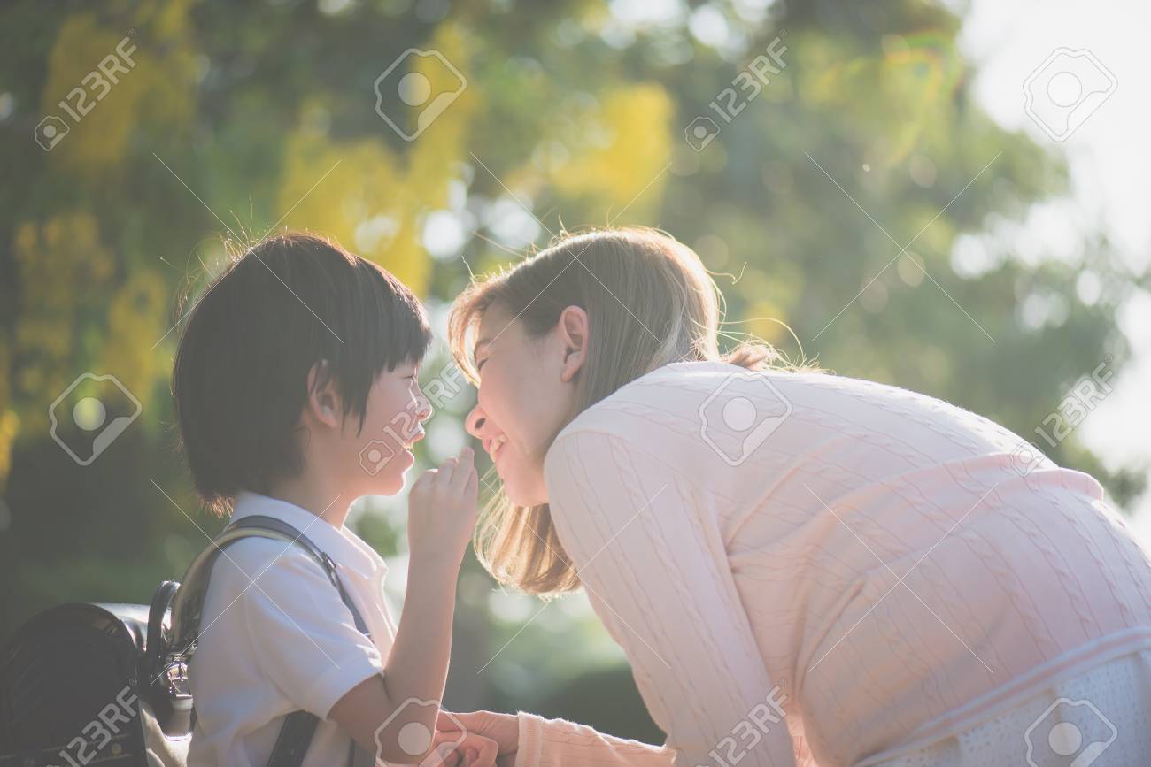 Asian child whispers something to his mother,back to school - 101362252 Asian child whispers something to his mother,back to school - 101362252