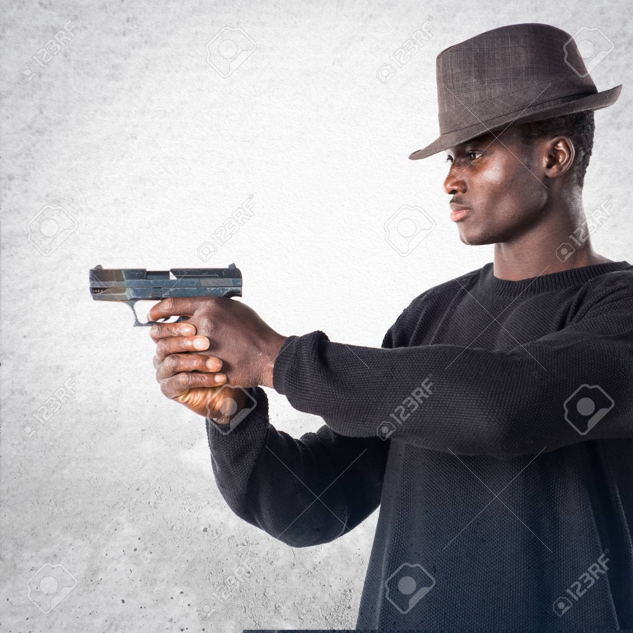 Black Man Holding A Pistol Stock Photo, Picture And Royalty Free Image.  Image 71025739.