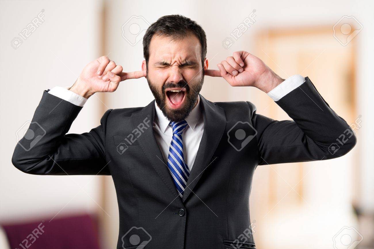 business man covering her ears over white background - 73719065 business man covering her ears over white background - 73719065