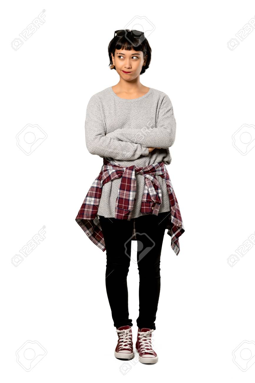 A Full Length Shot Of A Young Woman With Short Hair With Confuse