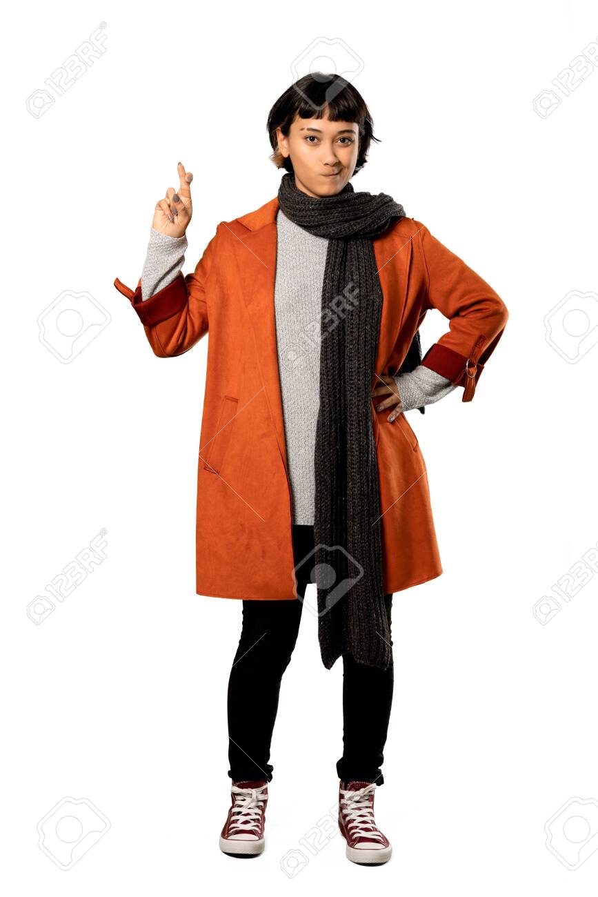 A Full Length Shot Of A Short Hair Woman With Coat With Fingers