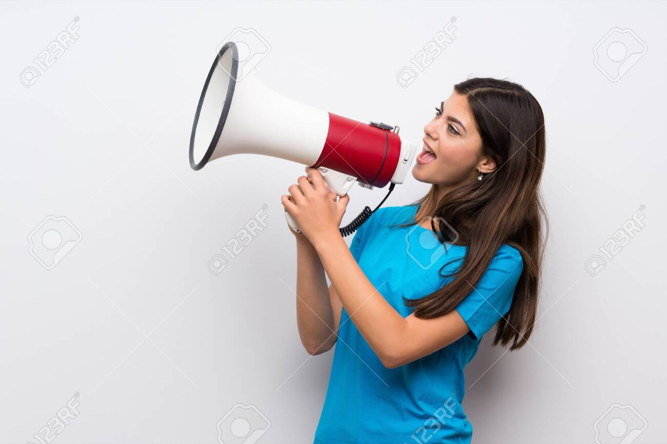 Teenager girl with blue shirt shouting through a megaphone - 121692274 Teenager girl with blue shirt shouting through a megaphone - 121692274