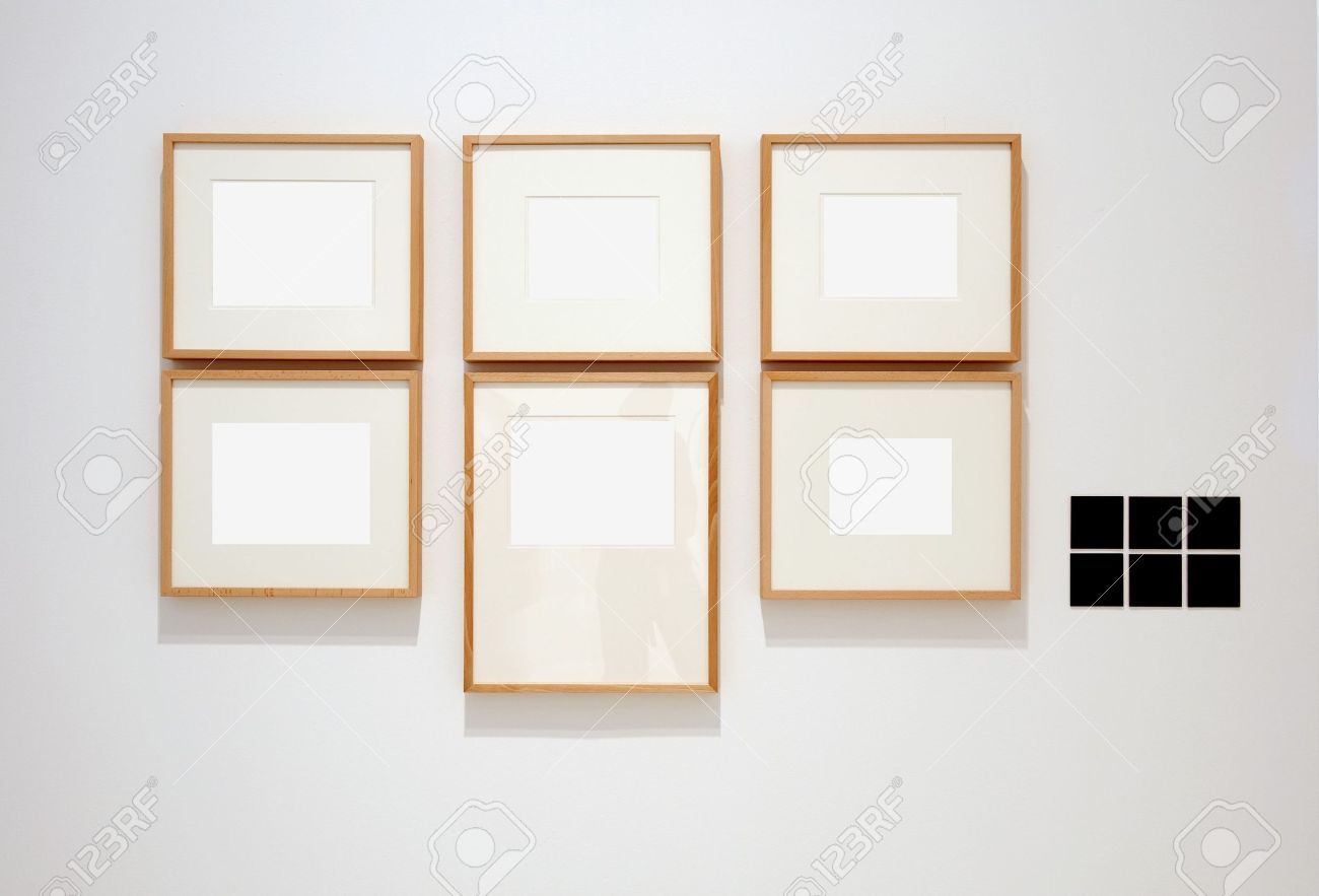 six empty frames on white wall in museum with labelssix empty frames on white wall in museum with labels stock photo 7102202