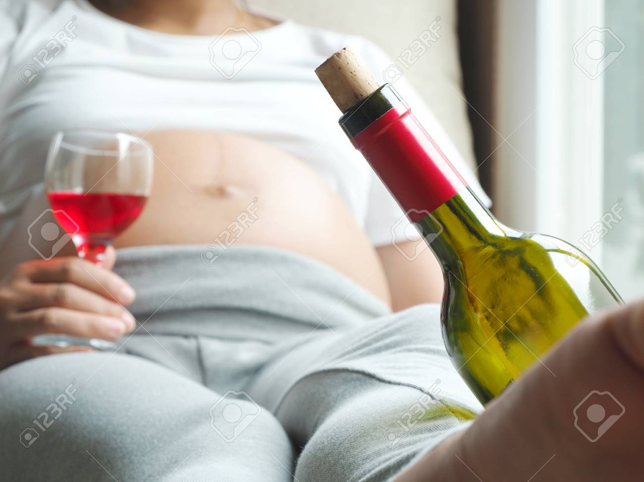 Wine Bottle With Background Of Pregnant Woman With Glass Of Wine Stock Photo Picture And Royalty Free Image Image 69226051