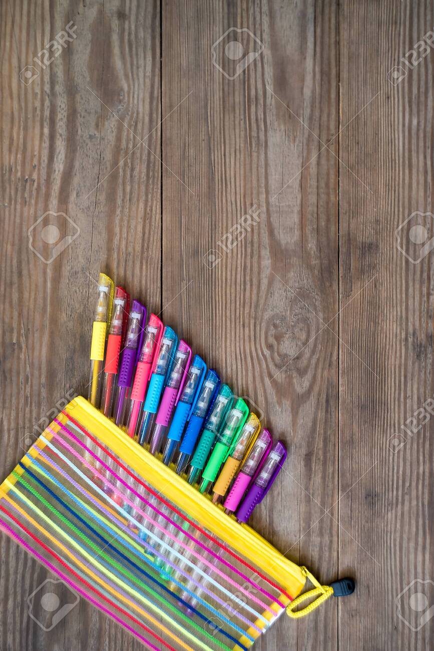 Set of multicolored gel pens on wooden background. School concept. Copy space. - 121366298 Set of multicolored gel pens on wooden background. School concept. Copy space. - 121366298