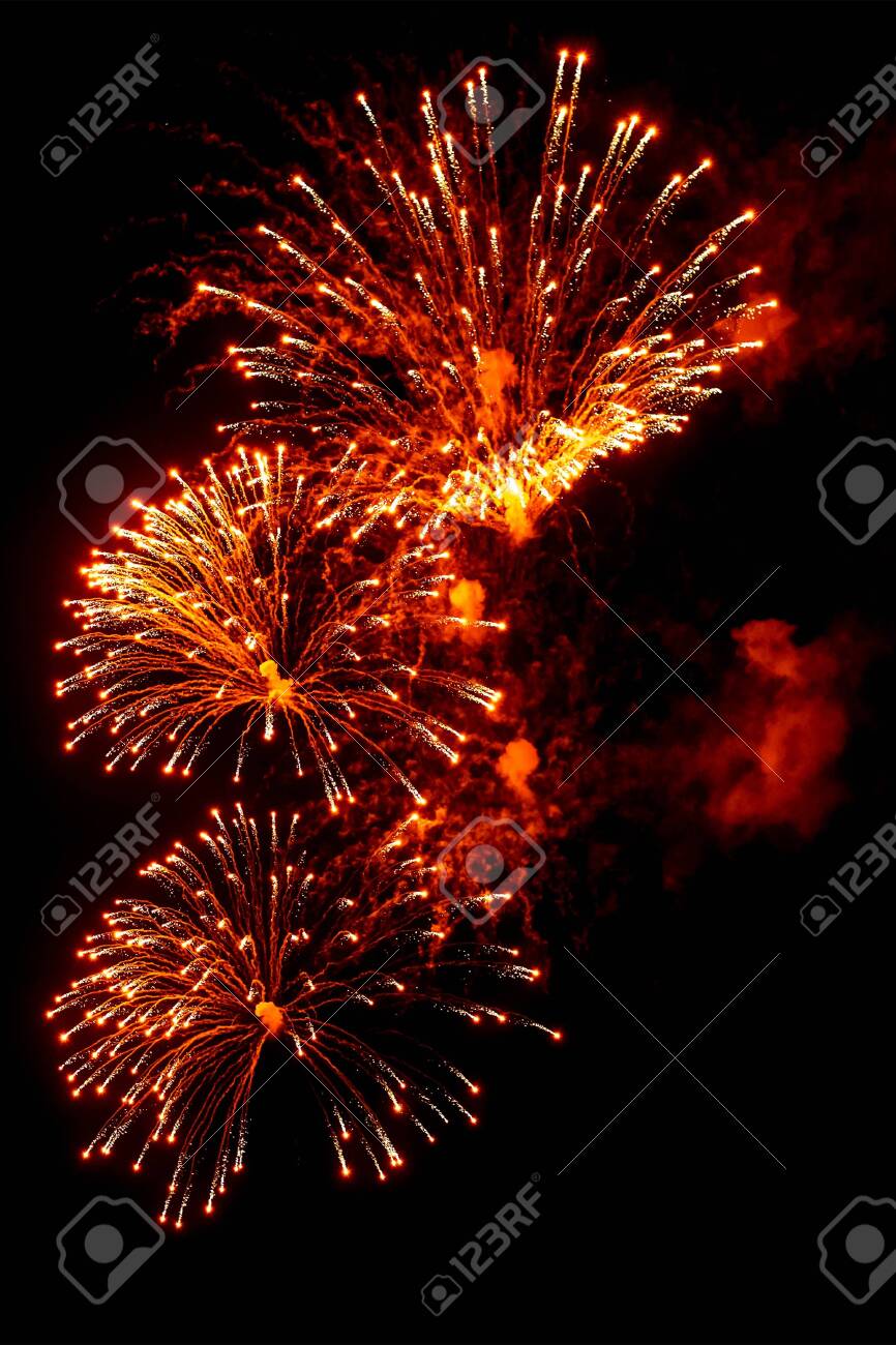 Close-up red and gold festive fireworks on a black background. Abstract holiday background - 135797486 Close-up red and gold festive fireworks on a black background. Abstract holiday background - 135797486