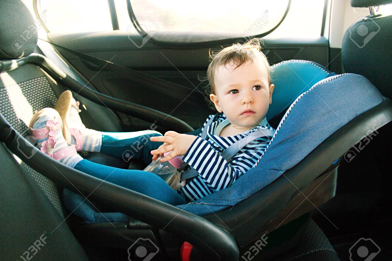 Baby Smile In A Safety Car Seat Security One Year Old Child Girl In Baby Smile In A Safety Car Seat Security One Year Old Child Girl In