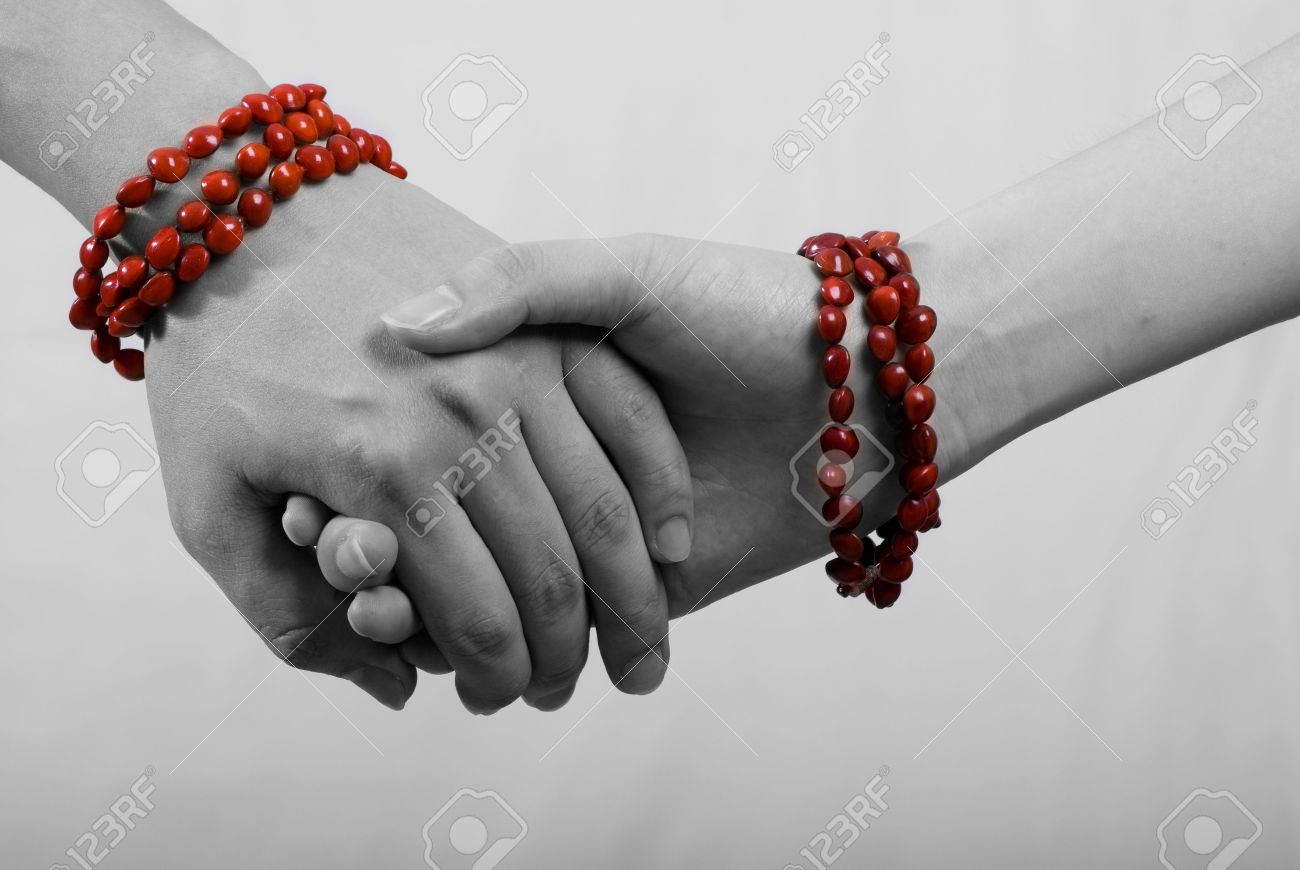 hand in hand with red bracelet in white background - 3276975 hand in hand with red bracelet in white background - 3276975