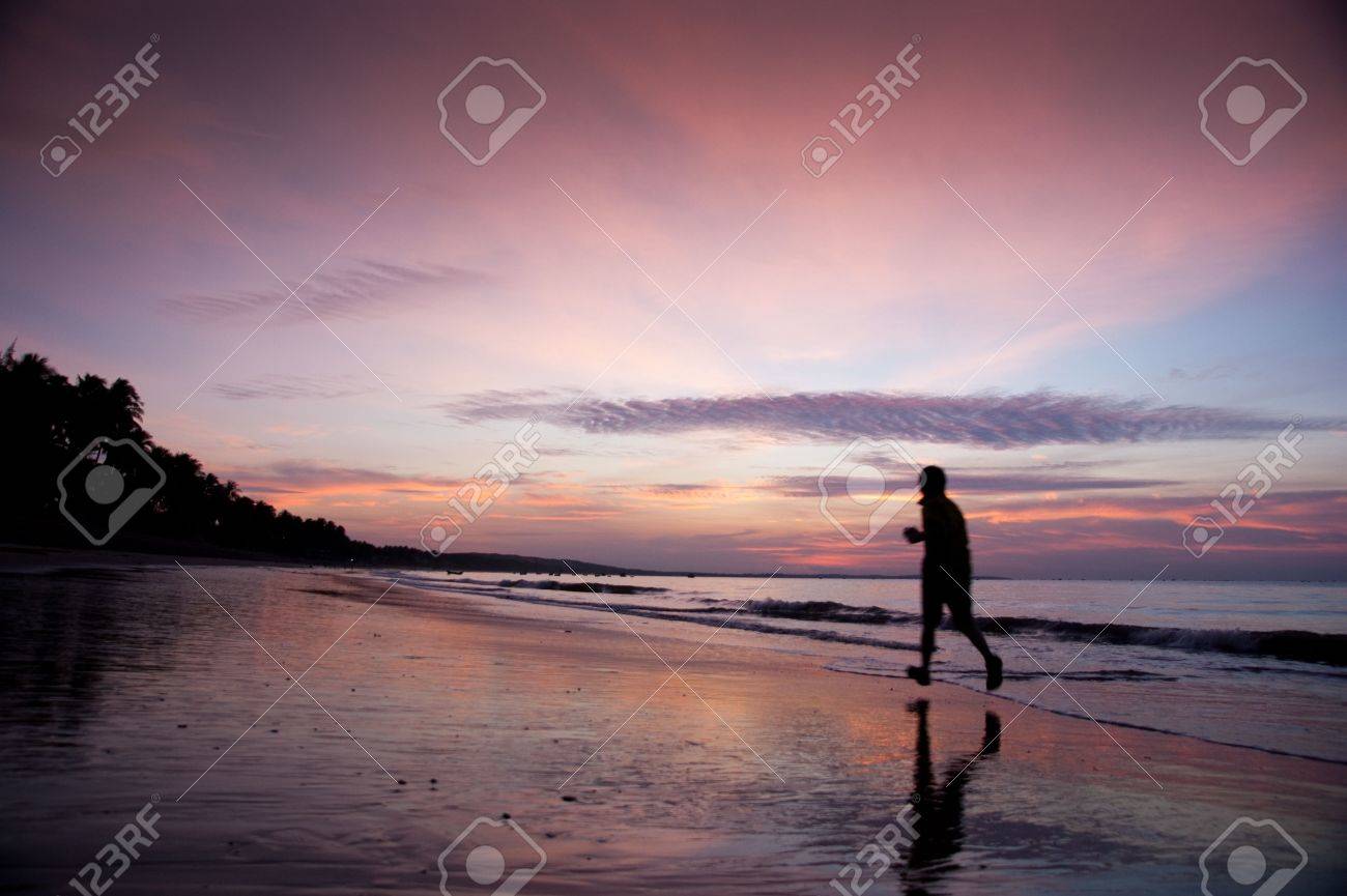 young man run along beach under moring sunrise - 6274443 young man run along beach under moring sunrise - 6274443