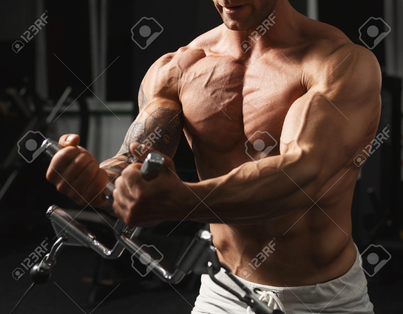 Strong muscular bodybuilder doing exercise on the chest in the crossover in the gym - 41670028 Strong muscular bodybuilder doing exercise on the chest in the crossover in the gym - 41670028