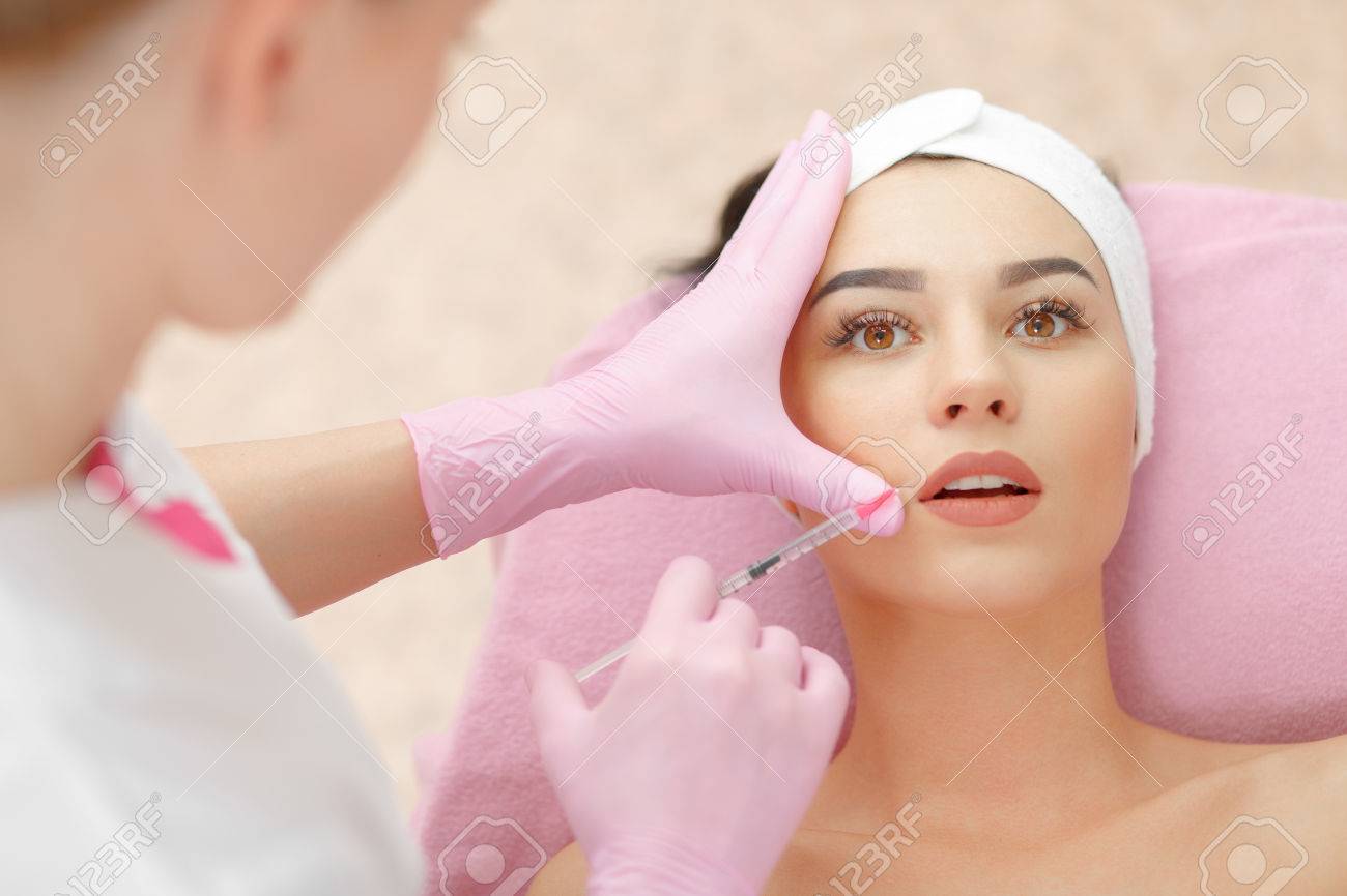 Beautiful woman gets injection in her lips. - 58918095 Beautiful woman gets injection in her lips. - 58918095
