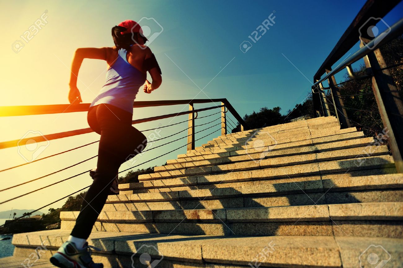 healthy lifestyle sports woman running up on stone stairs sunrise seaside - 49993472 healthy lifestyle sports woman running up on stone stairs sunrise seaside - 49993472