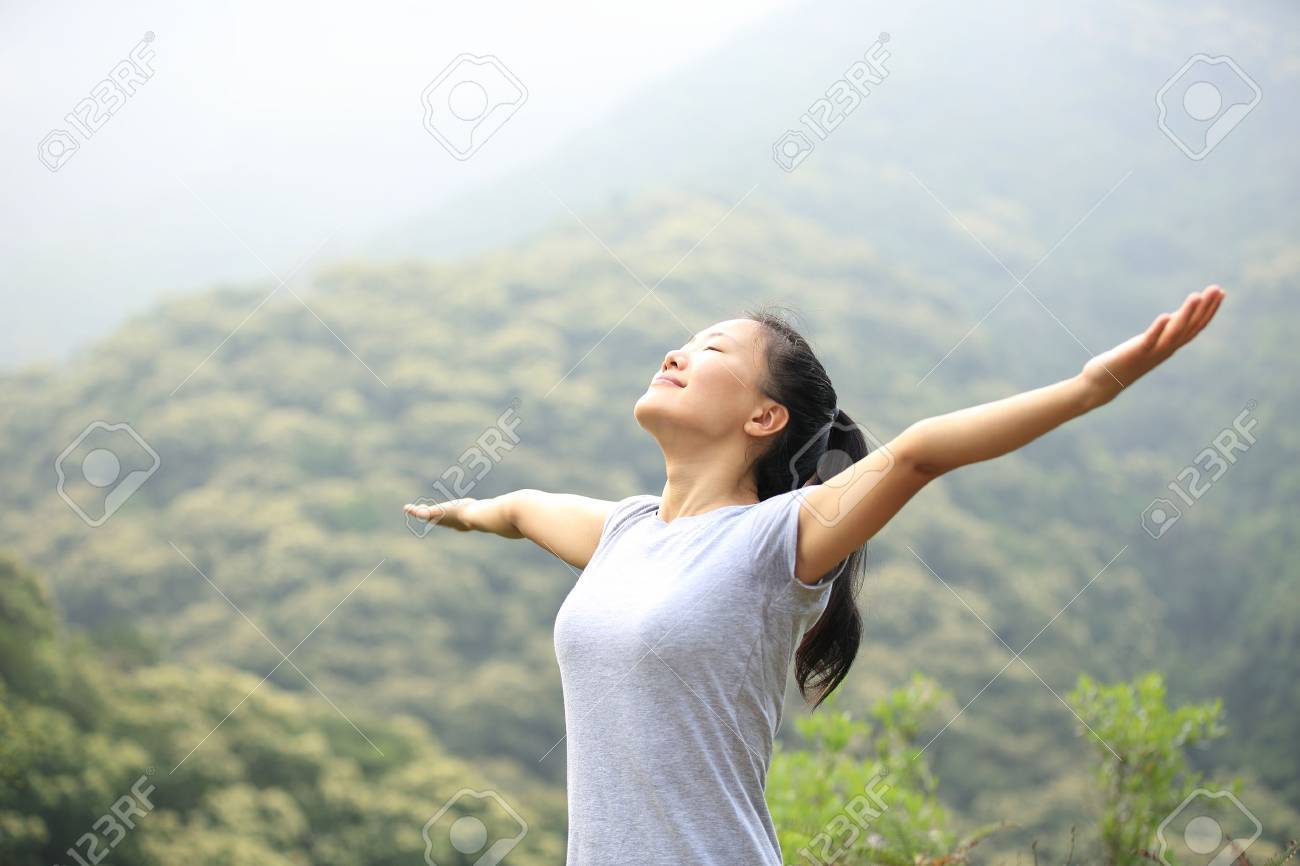 cheering woman enjoy the beautiful view at mountain peak - 49993477 cheering woman enjoy the beautiful view at mountain peak - 49993477