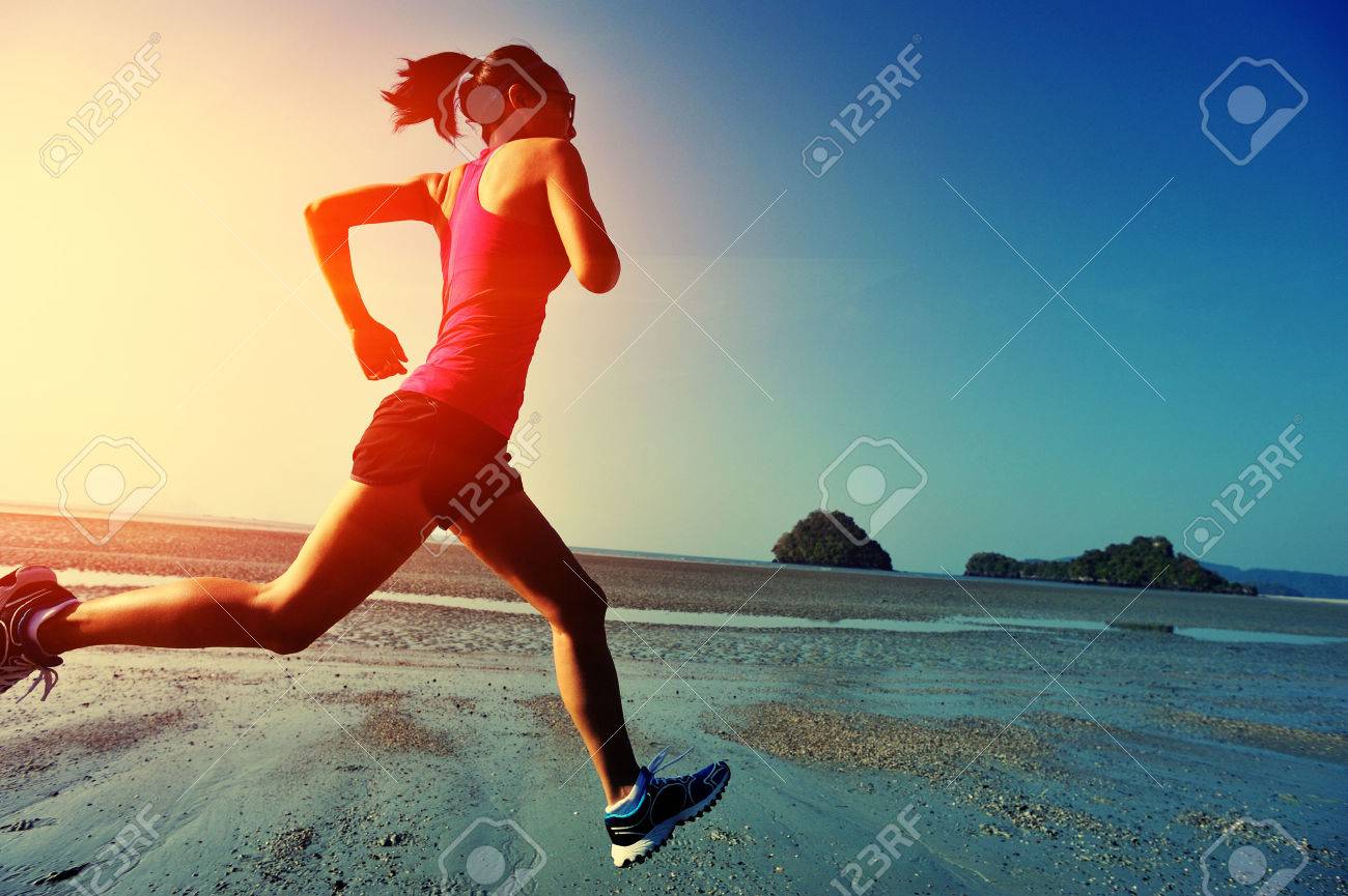 young healthy lifestyle woman running at sunrise beach - 50007183 young healthy lifestyle woman running at sunrise beach - 50007183