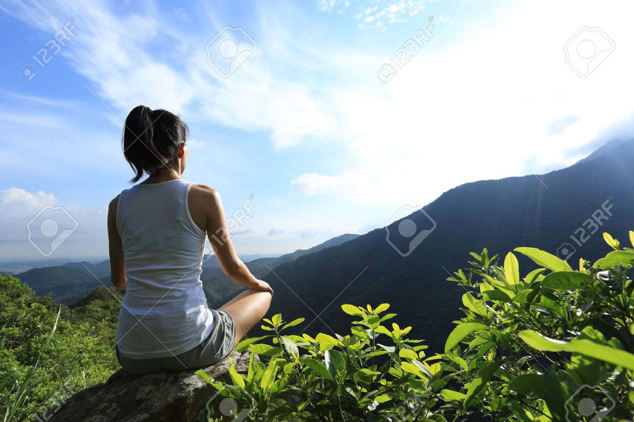 young fitness woman practice yoga at mountain peak rock - 49963056 young fitness woman practice yoga at mountain peak rock - 49963056