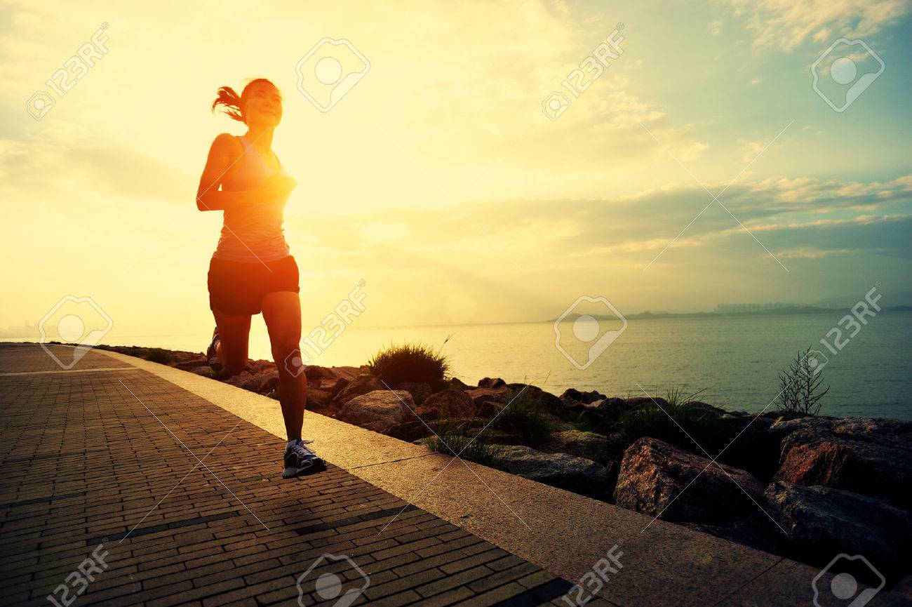 Runner athlete running at seaside. woman fitness silhouette sunrise jogging workout wellness concept. - 50504778 Runner athlete running at seaside. woman fitness silhouette sunrise jogging workout wellness concept. - 50504778
