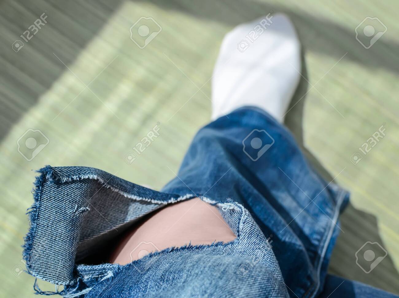 jeans with holes below the knee