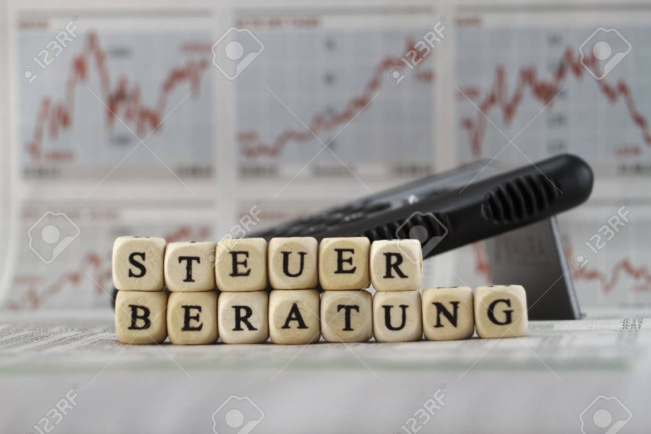 Tax consuting lettered with dice on a newspaper - 39316979 Tax consuting lettered with dice on a newspaper - 39316979