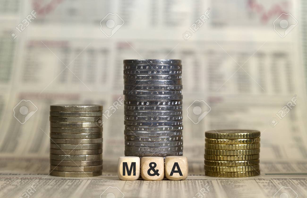 M&A winner's pedestal from coins on a newspaper - 116174960 M&A winner's pedestal from coins on a newspaper - 116174960