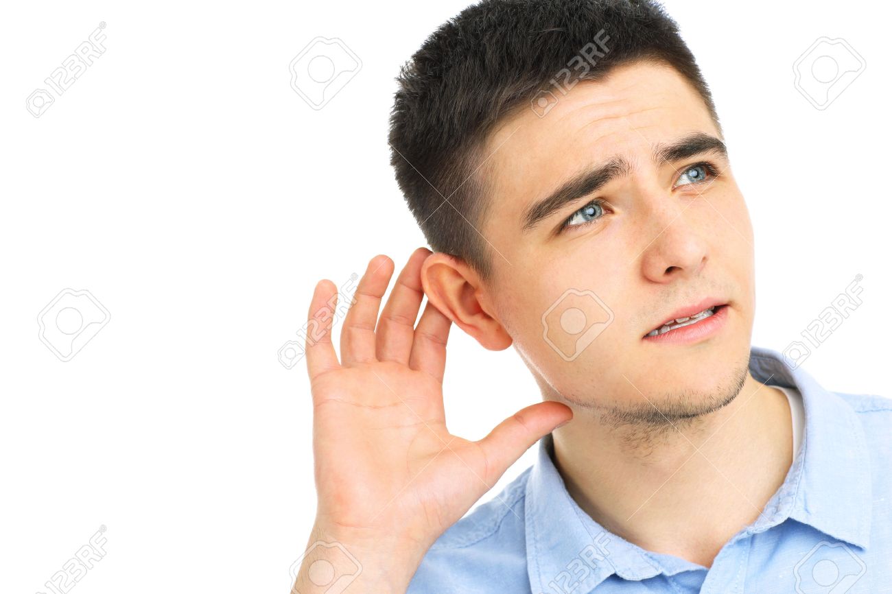 young man listening or hearing something over white background stock