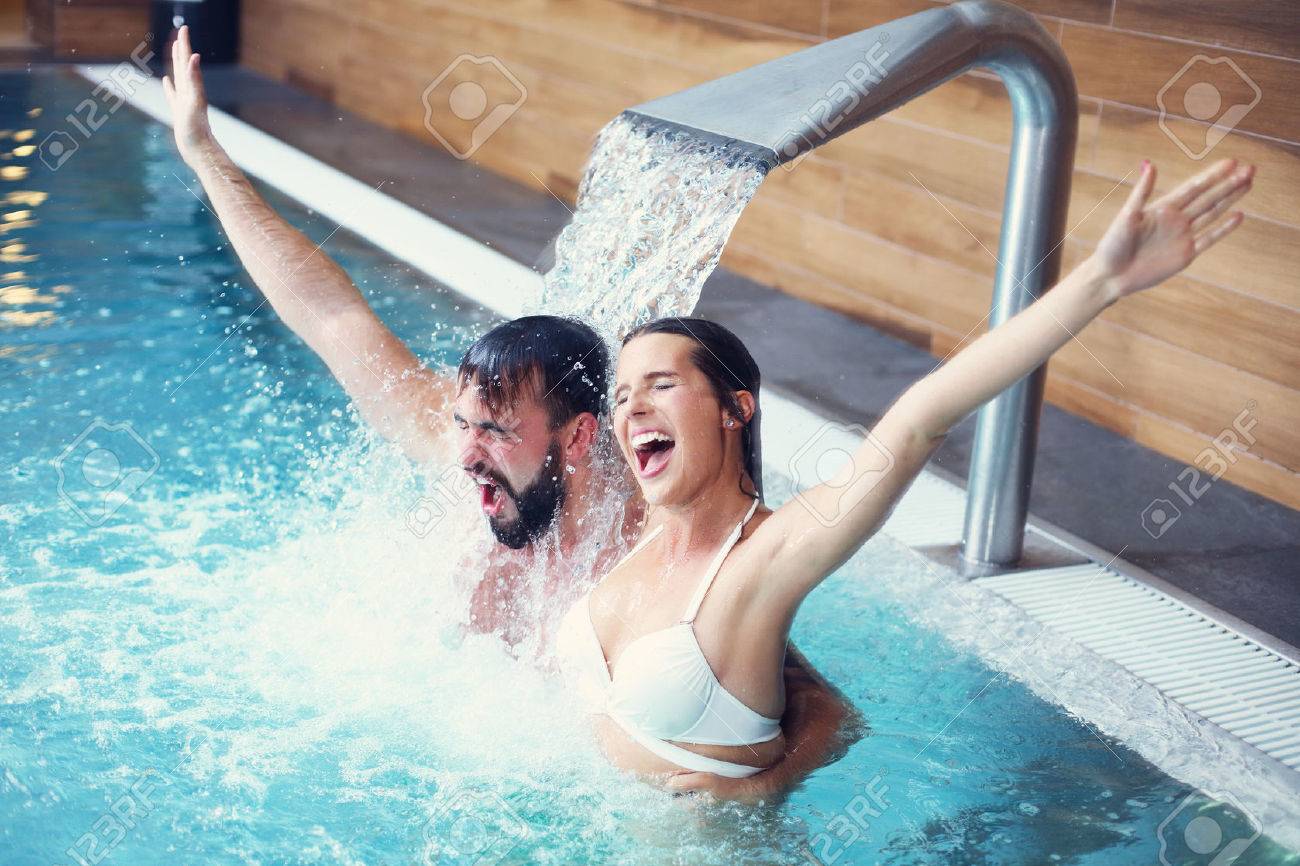 Picture of happy couple relaxing in pool spa - 64710890 Picture of happy couple relaxing in pool spa - 64710890