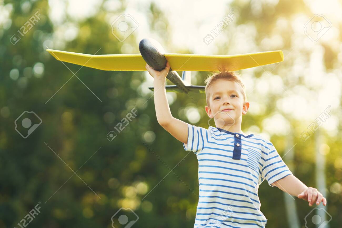 Happy 3 year old boy having fun playing with big plane outdoors - 128517556 Happy 3 year old boy having fun playing with big plane outdoors - 128517556
