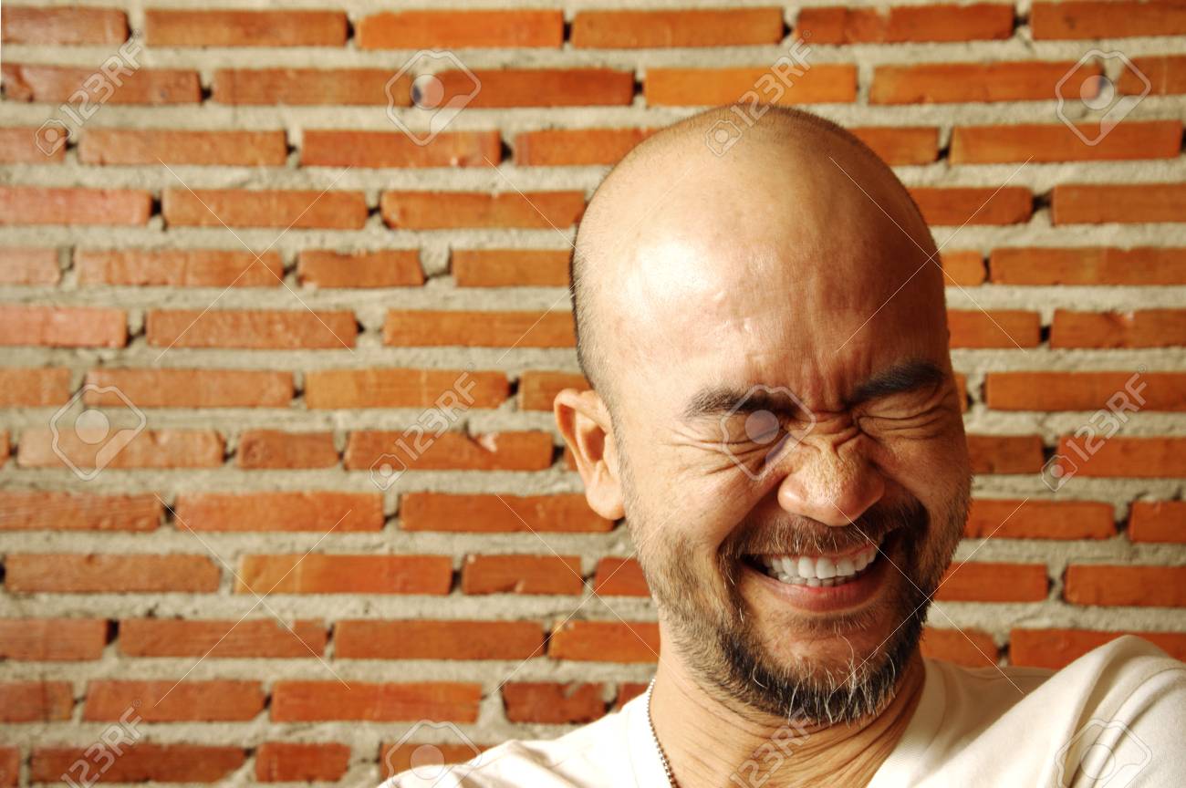 portrait cool asian japanese beard bald laughing man with brick