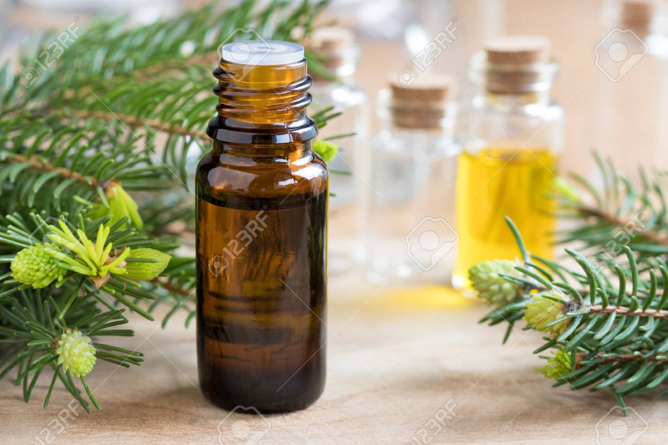 A bottle of fir essential oil with fir branches - 78157491 A bottle of fir essential oil with fir branches - 78157491