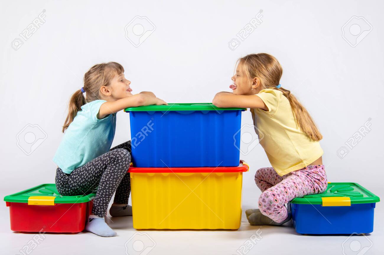 girls sit on toys