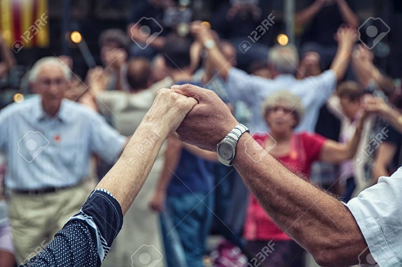View of senior people holding hands and dancing national dance Sardana at Plaza Nova, Barcelona, Spain. It is a type of circle dance typical of Catalonia - 38918983 View of senior people holding hands and dancing national dance Sardana at Plaza Nova, Barcelona, Spain. It is a type of circle dance typical of Catalonia - 38918983