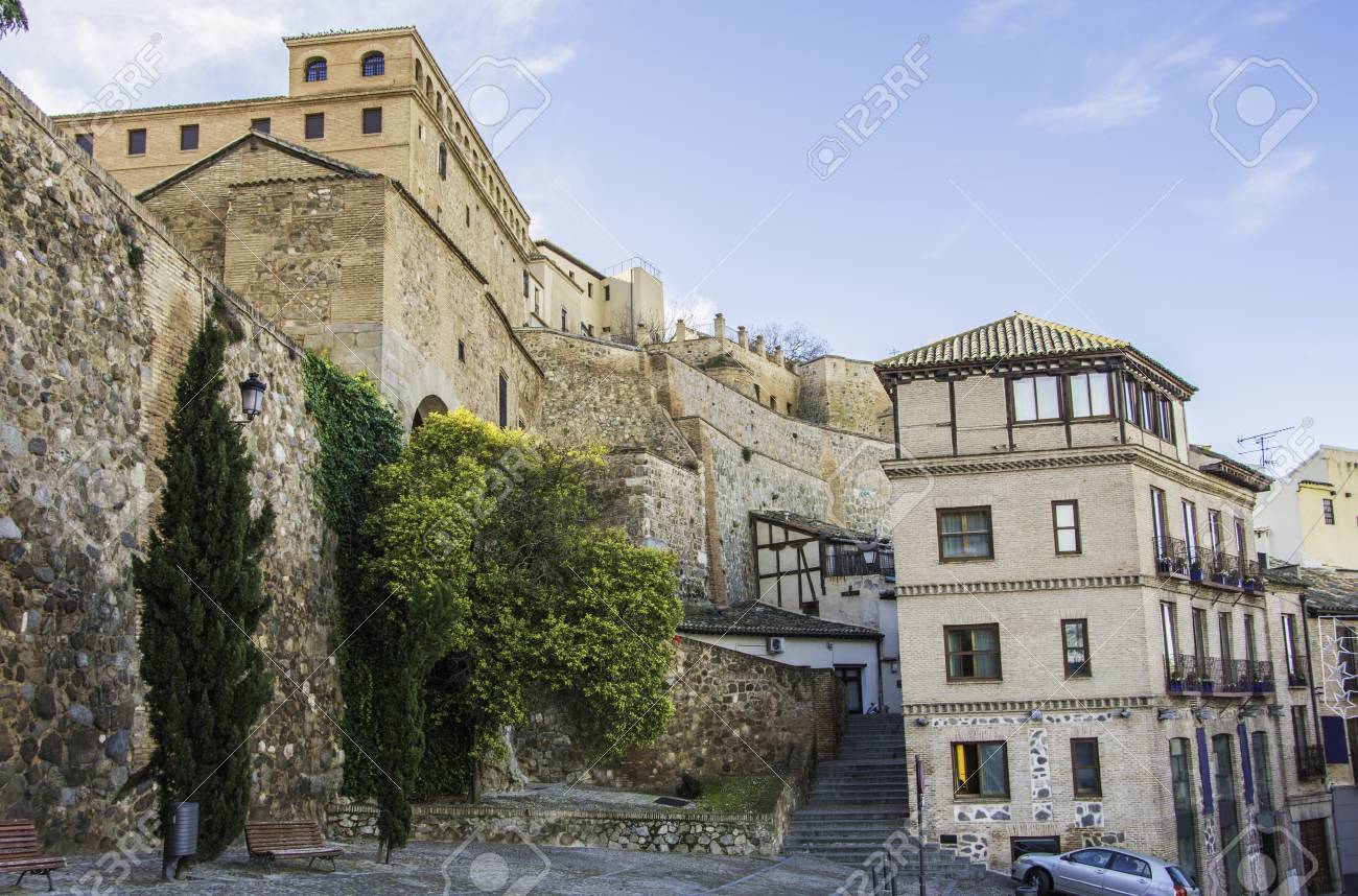 medieval style walls and buildings in the city of toledo facing