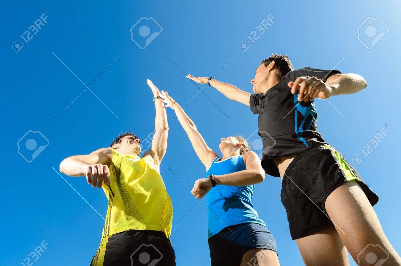 Young team with two men and woman, fiving and jumping for celebrate victory and achievements - 14274456 Young team with two men and woman, fiving and jumping for celebrate victory and achievements - 14274456
