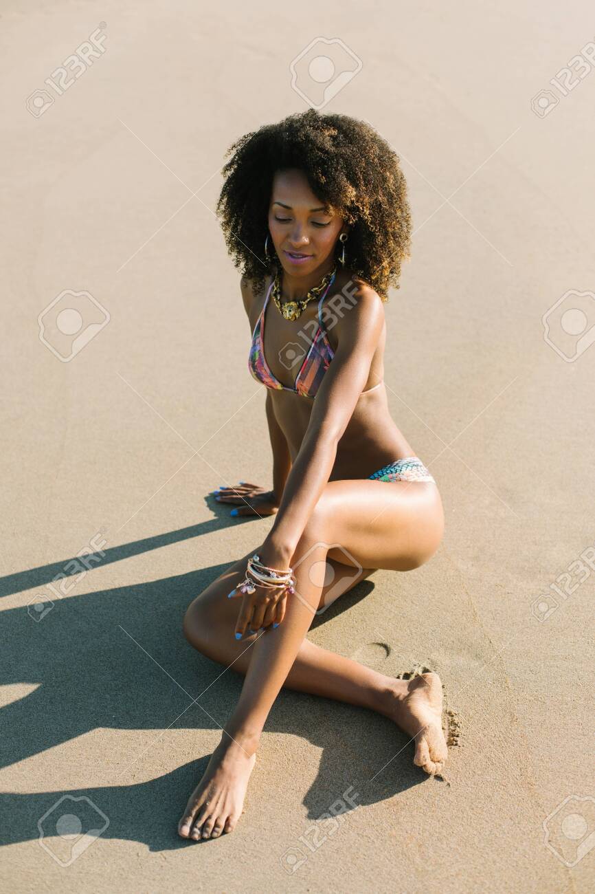 Young Beautiful Black Woman Relaxing At The Beach On Summer