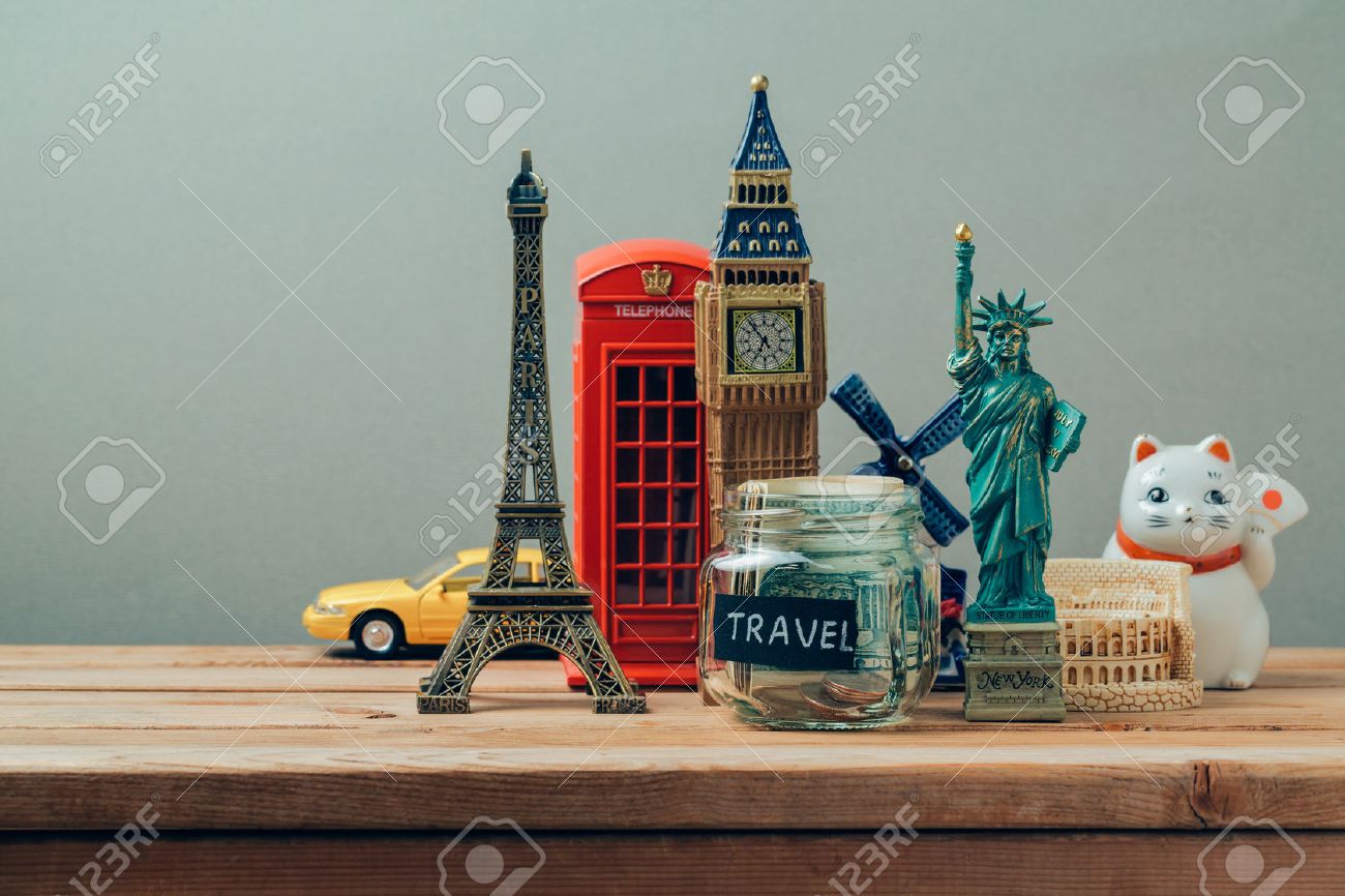 Travel and tourism concept with souvenirs from around the world. Planning summer vacation, money budget trip concept. Saving money for vacation. - 56212216 Travel and tourism concept with souvenirs from around the world. Planning summer vacation, money budget trip concept. Saving money for vacation. - 56212216