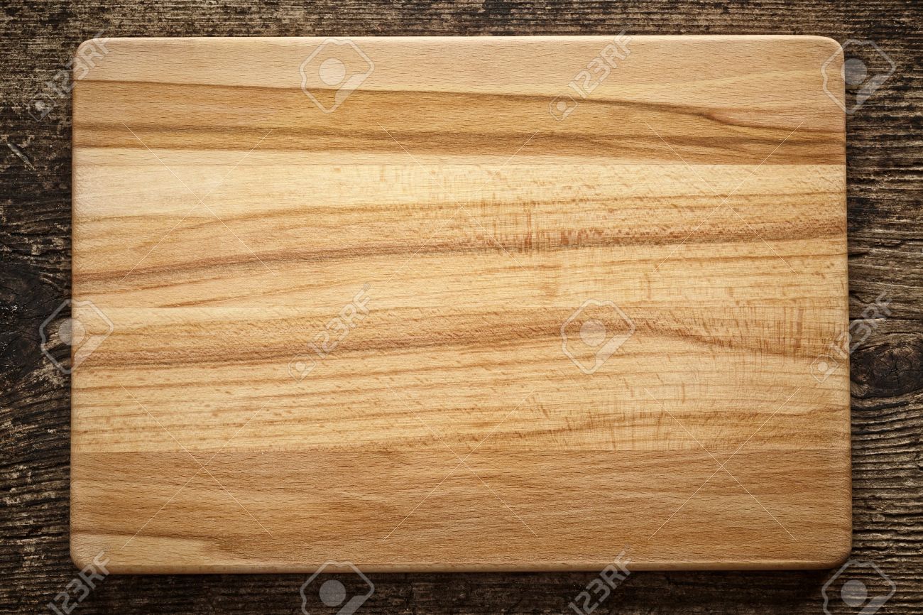 top view of wooden cutting board on old wooden table stock photo