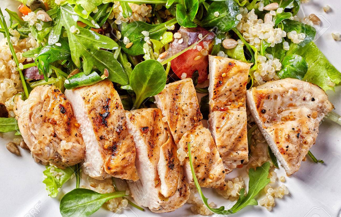 Quinoa and vegetable salad with grilled chicken fillet, top view - 50860913 Quinoa and vegetable salad with grilled chicken fillet, top view - 50860913