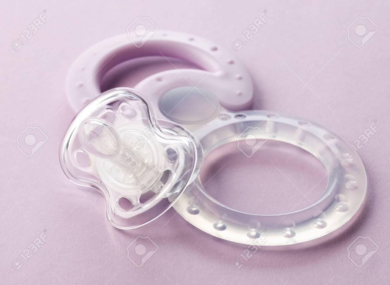 Sucette Transparente Et Jouets Pour Bebes En Plastique Sur Fond Rose Banque D Images Et Photos Libres De Droits Image 6903