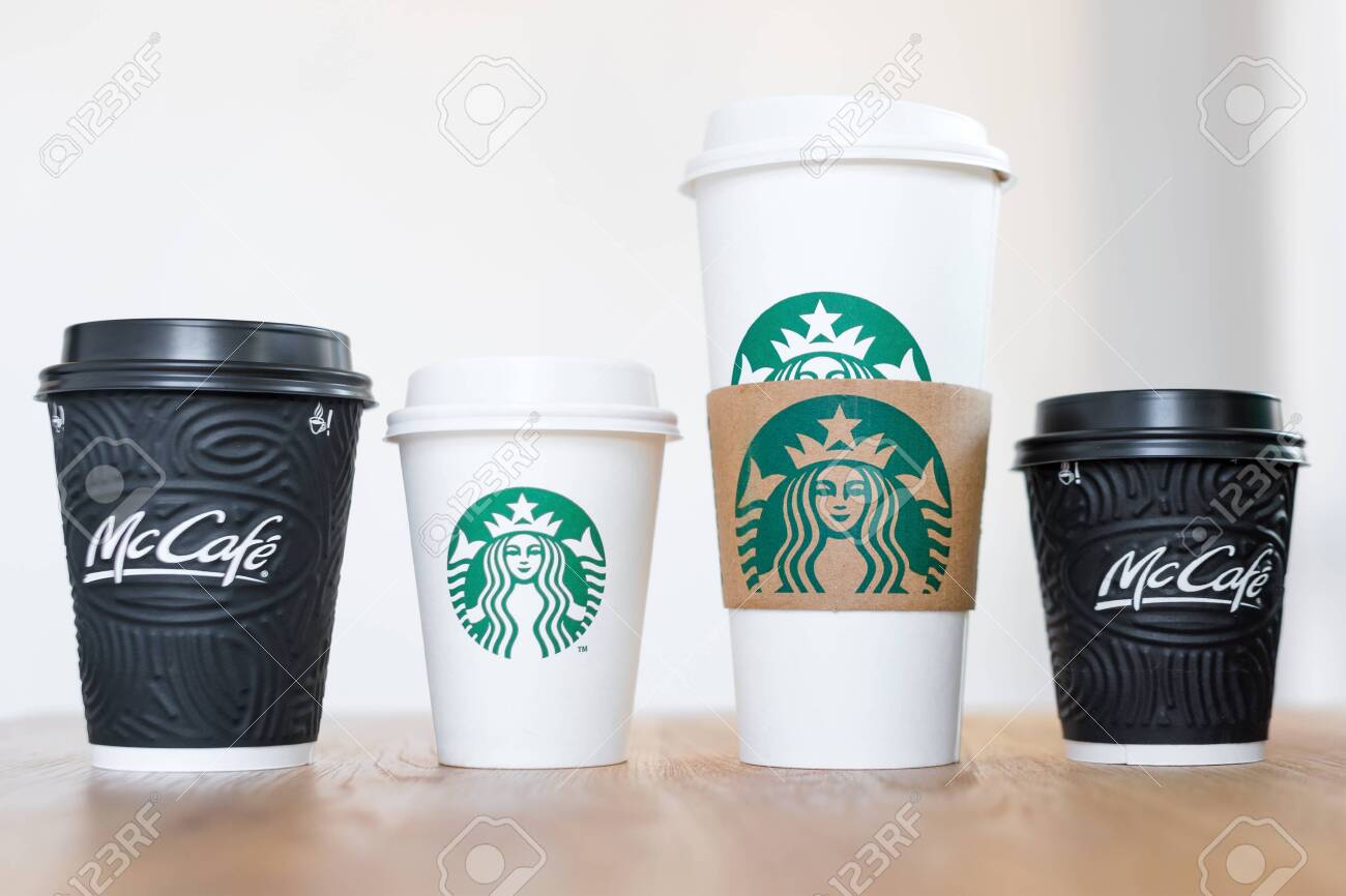 Kiev Ukraine November 06 2019 Four Cups Of Starbucks Coffee And Mcdonalds Coffee On Wooden Table On Light Background Brand Confrontation Customer Choice And Globalization Concept Stock Photo Picture And Royalty