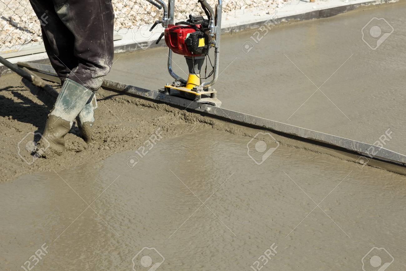 Smoothing Fresh Concrete With Gas Powered Vibrating Screed Machine On A Construction Site Stock Photo Picture And Royalty Free Image Image 76409729