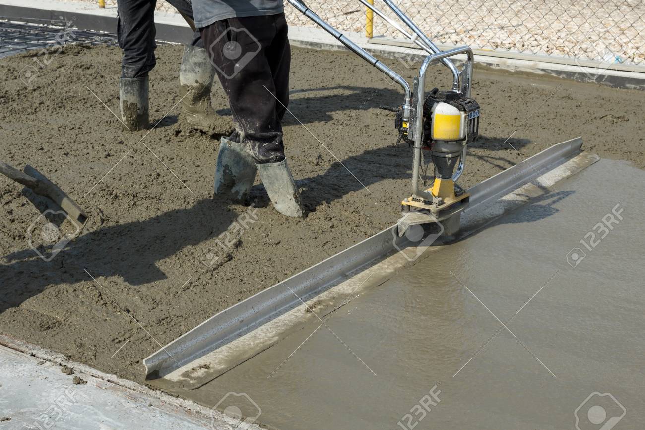 Smoothing Fresh Concrete With Gas Powered Vibrating Screed Machine On A Construction Site Stock Photo Picture And Royalty Free Image Image 77820303
