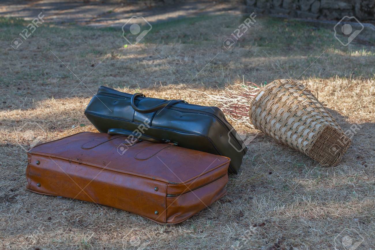 Two old suitcases on the grass close-up. - 89034738 Two old suitcases on the grass close-up. - 89034738