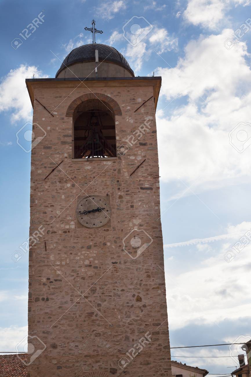 Bell tower with a clock on the background of the sky with clouds. - 93088251 Bell tower with a clock on the background of the sky with clouds. - 93088251