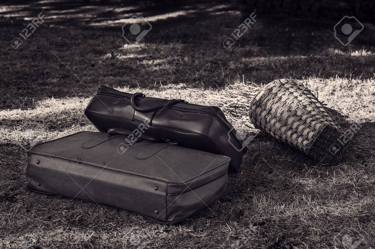 Two old suitcases on the grass close-up. - 93472821 Two old suitcases on the grass close-up. - 93472821