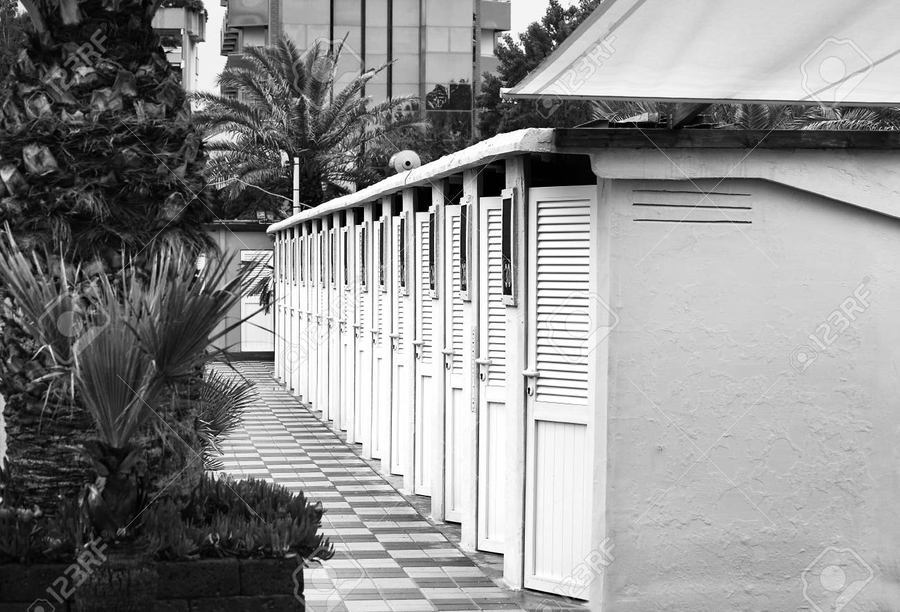 Beach cabins among palm trees and flowers close-up. - 93448709 Beach cabins among palm trees and flowers close-up. - 93448709