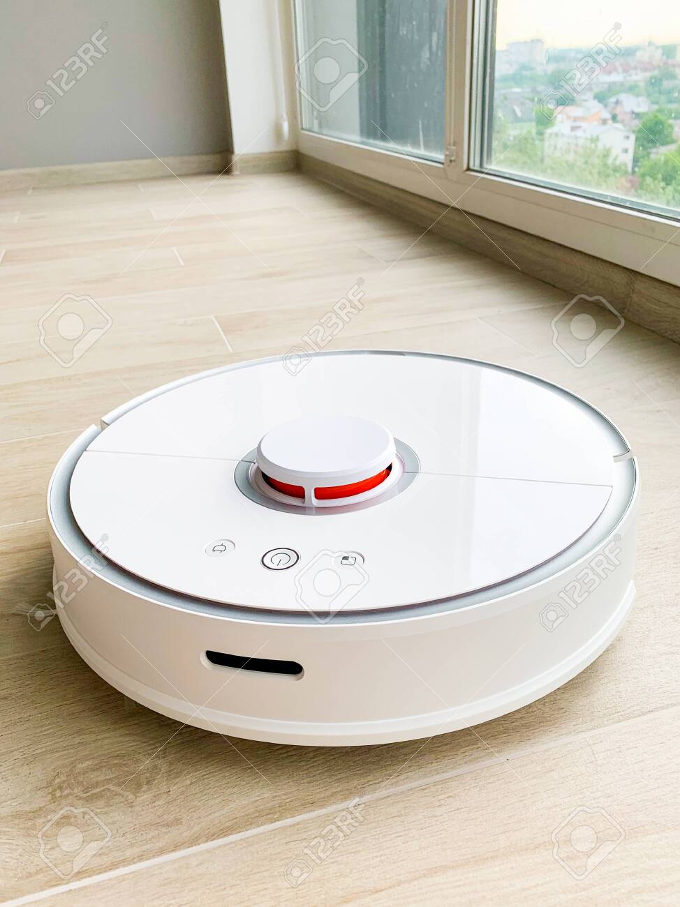 White Robot Cleaner Robot Vacuum Cleaner On Laminate Floor In